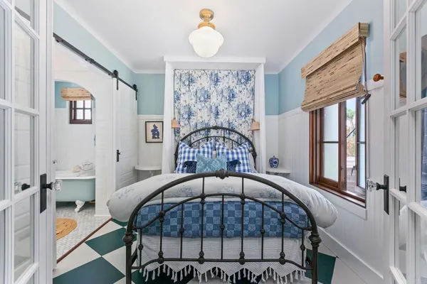 a view of a bedroom with furniture and window