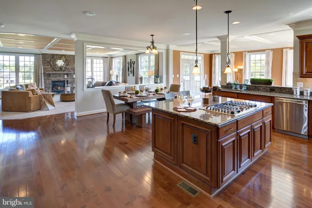 a large kitchen with stainless steel appliances a stove a sink dishwasher and a dining table with garden