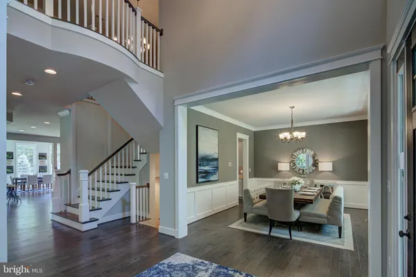 a living room with furniture and a dining table