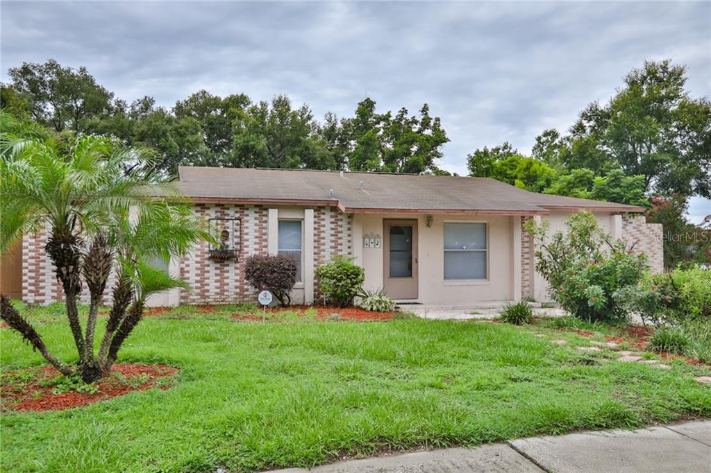 1007 Park Street Seffner, FL 33584 - Photo 1 of 1 a view of a house with a yard and potted plants