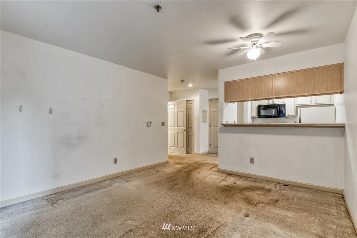 506 East Howell Street, Unit 108 Seattle, WA 98122 - Photo 6 of 20 a view of a kitchen with a stove and cabinets