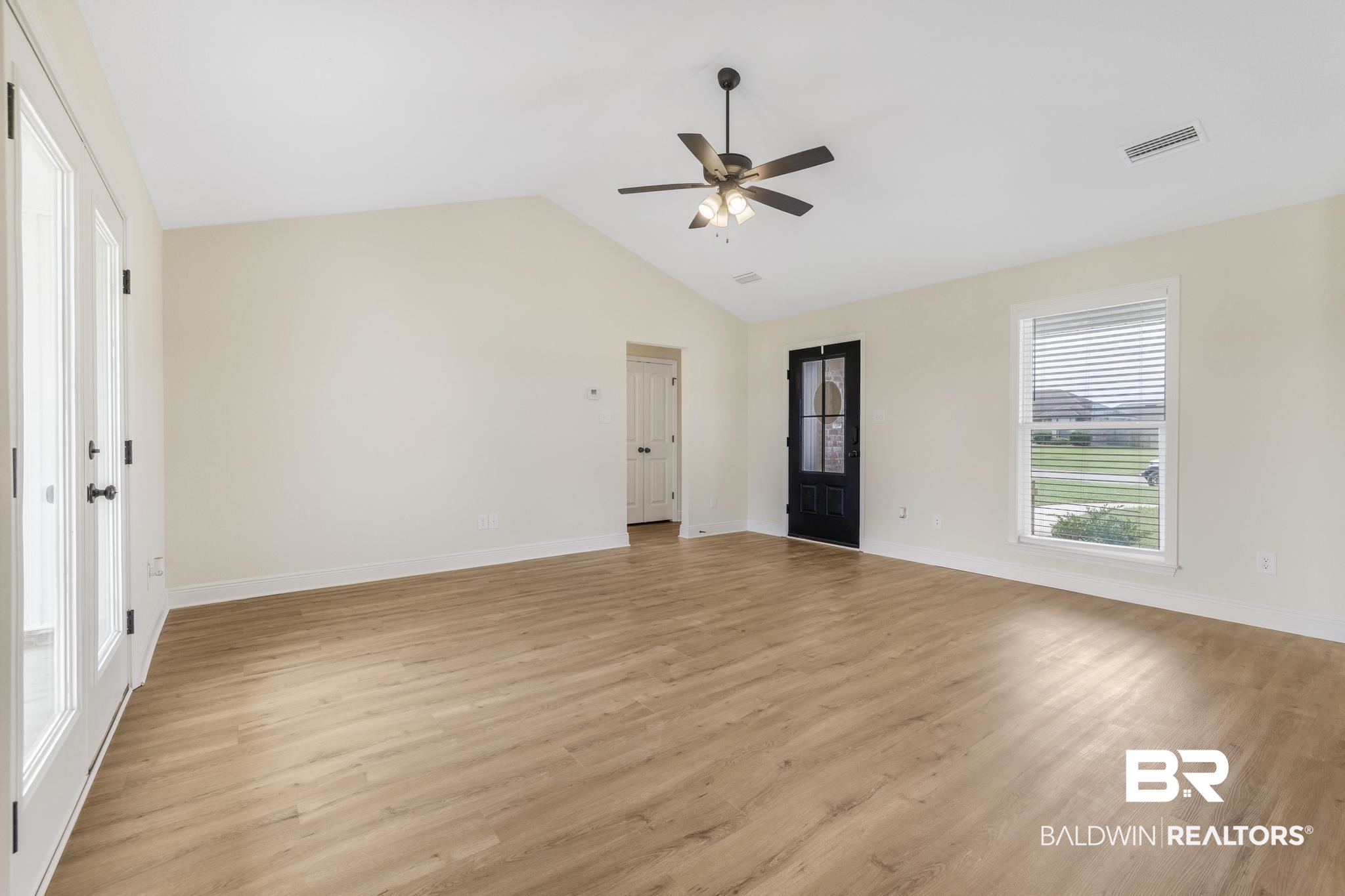 21580 Talbot Lane Robertsdale, AL 36567 - Photo 6 of 25 Unfurnished room with light wood-type flooring, vaulted ceiling, and a ceiling fan