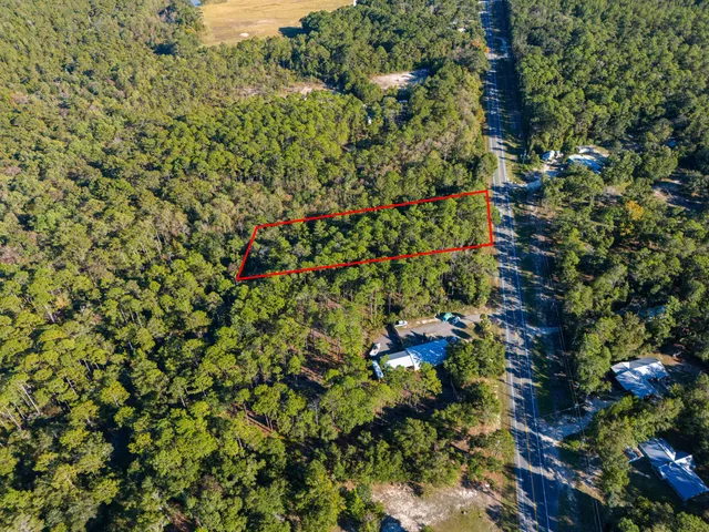 an aerial view of a houses with a yard