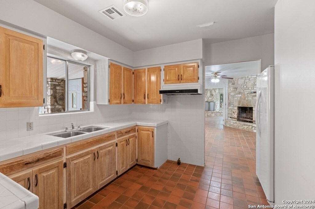 6268 Highway 27 Center Point, TX 78010 - Photo 13 of 39 a kitchen with a sink cabinets and window