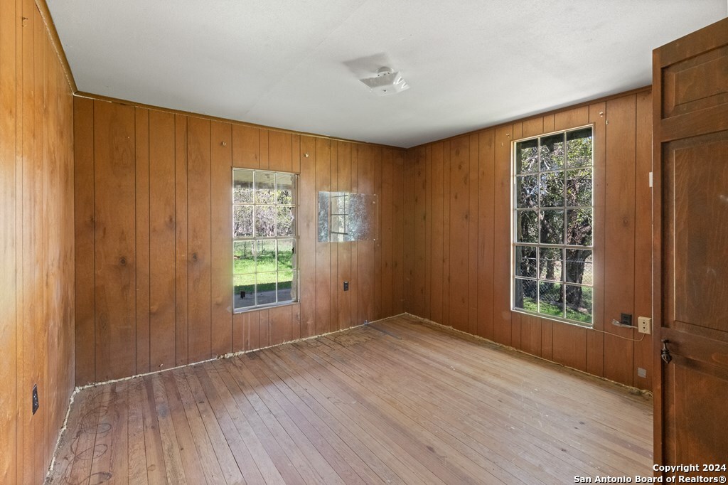 6268 Highway 27 Center Point, TX 78010 - Photo 23 of 39 a view of an empty room with wooden floor and a window