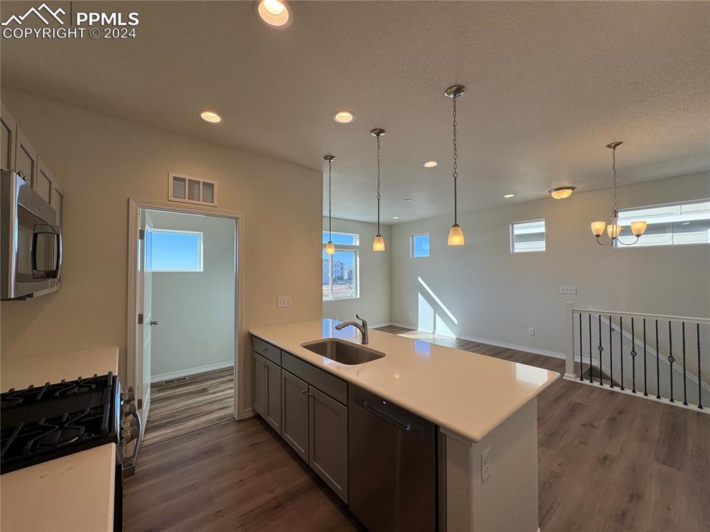 8082 Jayla Trail Peyton, CO 80831 - Photo 11 of 20 a kitchen with a sink a refrigerator and wooden floor