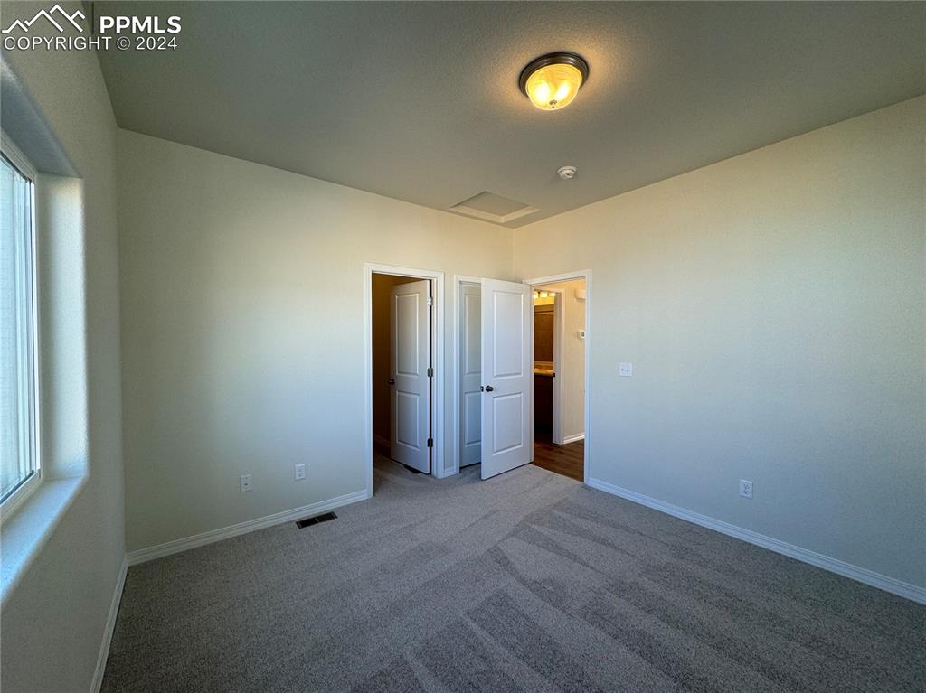 8082 Jayla Trail Peyton, CO 80831 - Photo 14 of 20 an empty room with fan and entrance