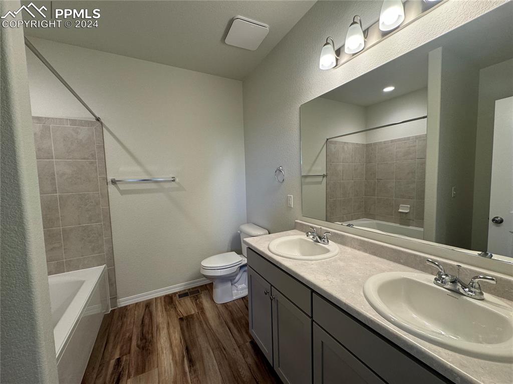 8082 Jayla Trail Peyton, CO 80831 - Photo 19 of 20 a bathroom with a sink a toilet a mirror and shower