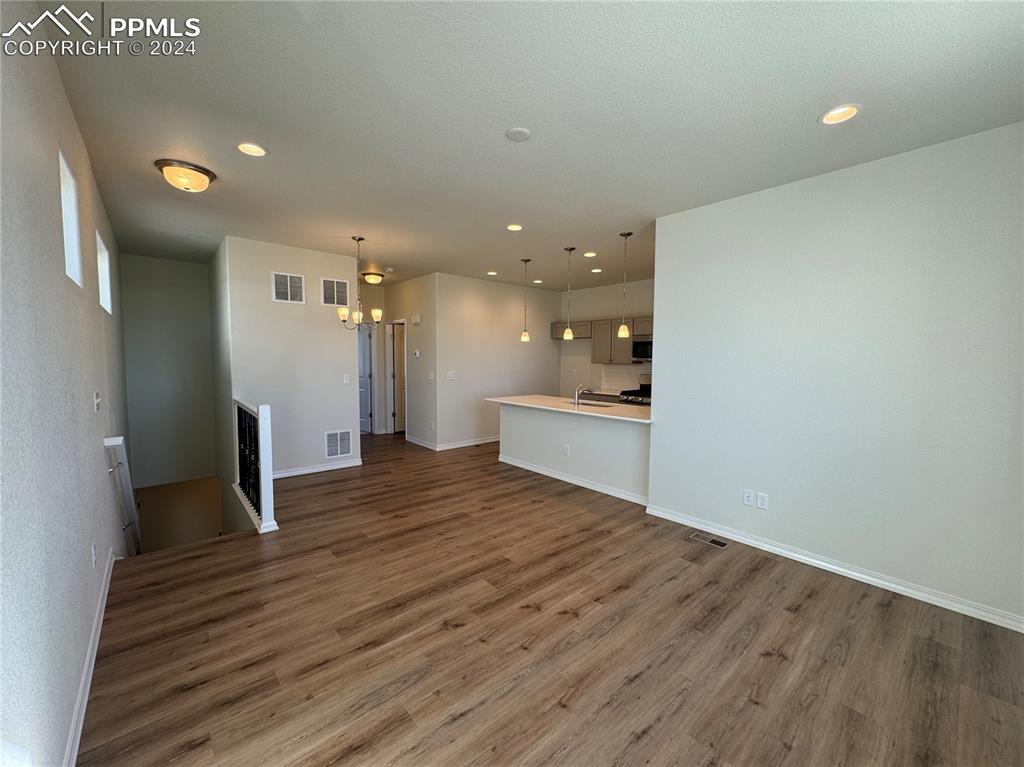 8082 Jayla Trail Peyton, CO 80831 - Photo 6 of 20 a view of kitchen and hall with wooden floor