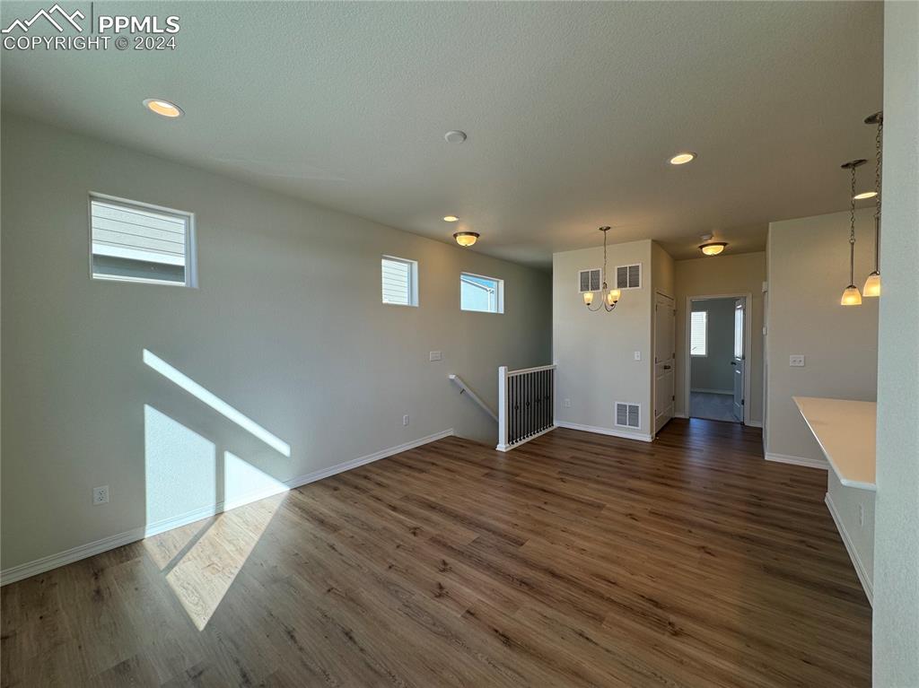 8082 Jayla Trail Peyton, CO 80831 - Photo 7 of 20 a view of an empty room with wooden floor and a window