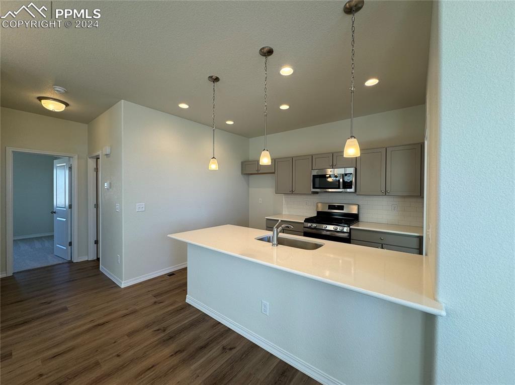 8082 Jayla Trail Peyton, CO 80831 - Photo 9 of 20 a kitchen with stainless steel appliances a sink stove and refrigerator