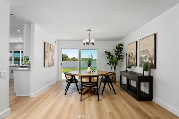 a kitchen with stainless steel appliances kitchen island granite countertop a kitchen island hardwood floor and a sink
