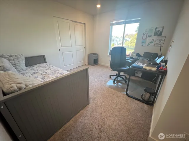a bedroom with a bed and a chair