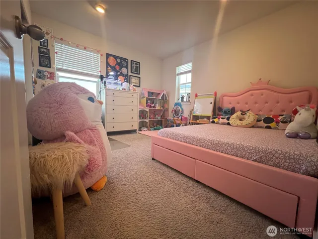 a bedroom with furniture and a large window