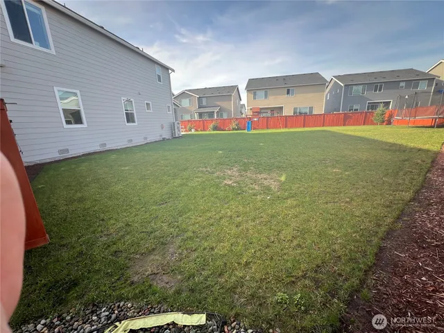 a view of a house with a backyard