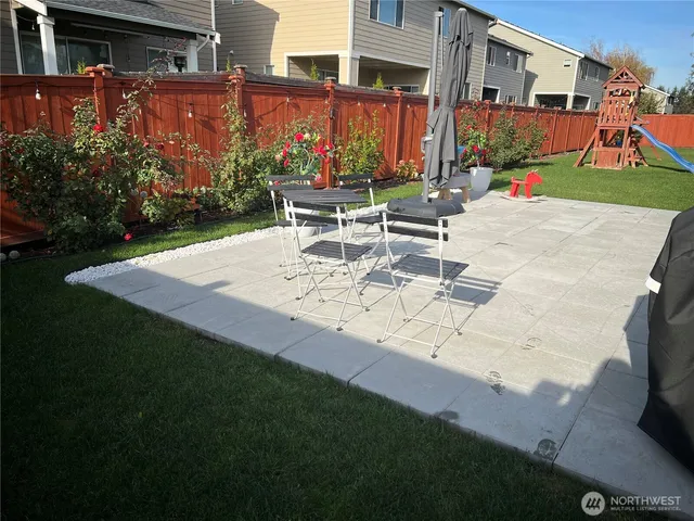 a view of a patio with couches table and chairs potted plants