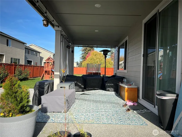 a outdoor space with the couches and dining table with the garden view