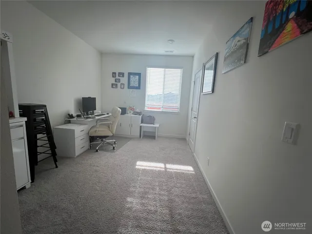 a room with furniture a air conditioner vent and a window