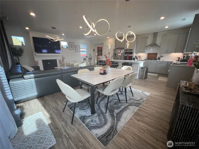 a large kitchen with a table and chairs in it