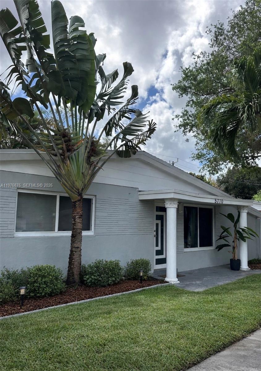 5710 Douglas Street Hollywood, FL 33021 - Photo 1 of 21 a front view of house with yard and green space