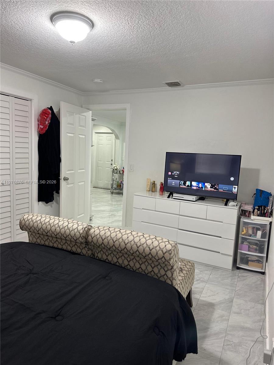 5710 Douglas Street Hollywood, FL 33021 - Photo 14 of 21 a bedroom with a bed and a dresser