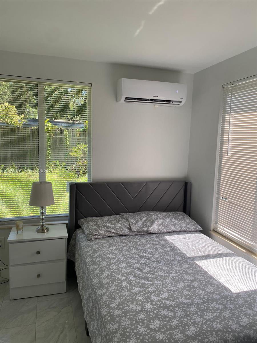 5710 Douglas Street Hollywood, FL 33021 - Photo 15 of 21 a bedroom with a bed and a window