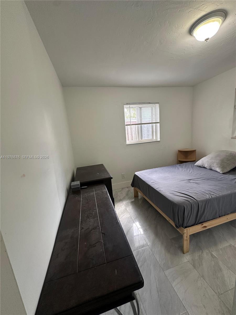 5710 Douglas Street Hollywood, FL 33021 - Photo 8 of 21 a bedroom with a bed and window