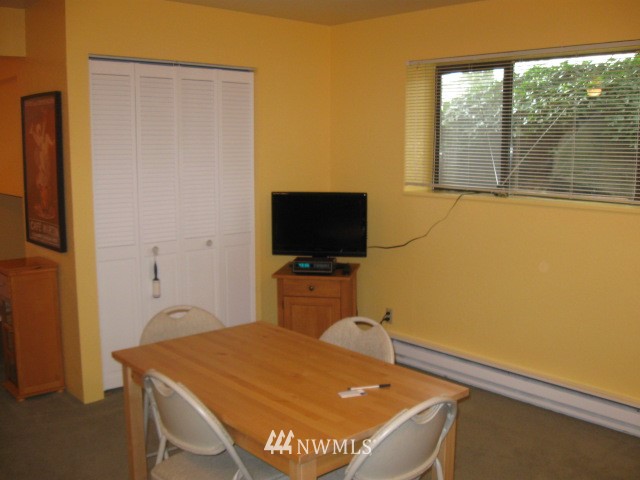 8500 Linden Avenue North Seattle, WA 98103 - Photo 11 of 17 a room with a bed and a flat screen tv