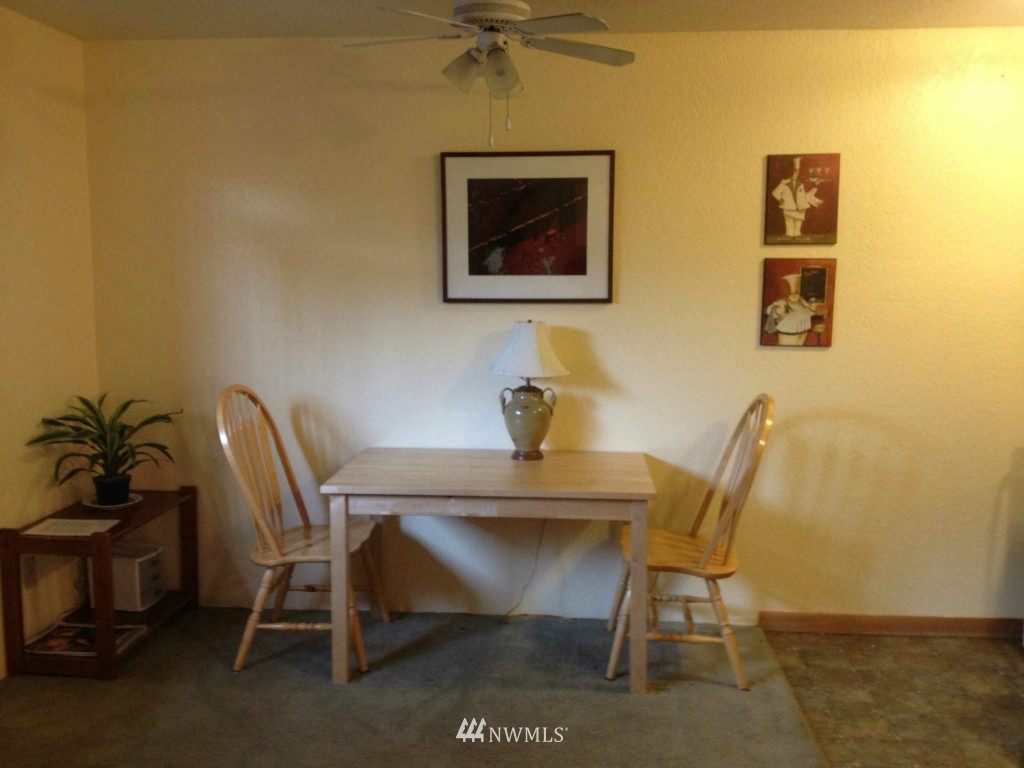 8500 Linden Avenue North Seattle, WA 98103 - Photo 3 of 17 a view of a dining room with furniture and a potted plant