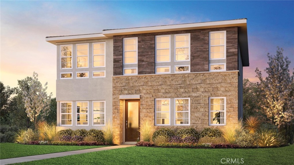 front view of a brick house with a yard