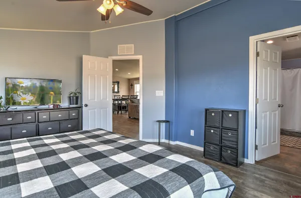 a bedroom with a bed and a dresser in it