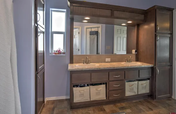a bathroom with a granite countertop sink and a mirror