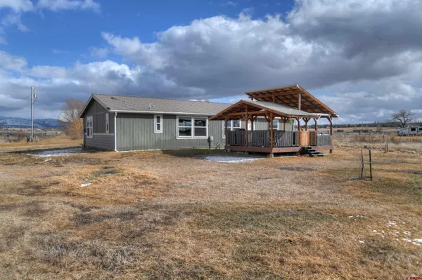 a front view of a house with a garden and plants