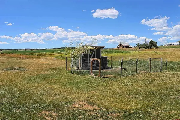 a view of yard with swimming pool and deck
