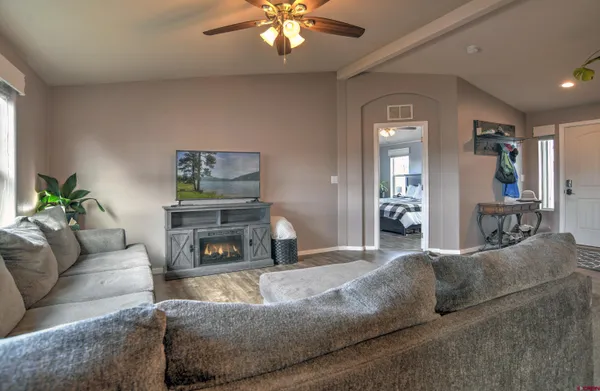 a living room with furniture and a fireplace