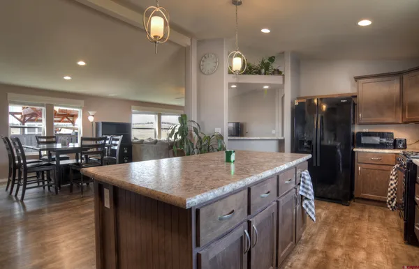 a kitchen with a table chairs refrigerator and microwave
