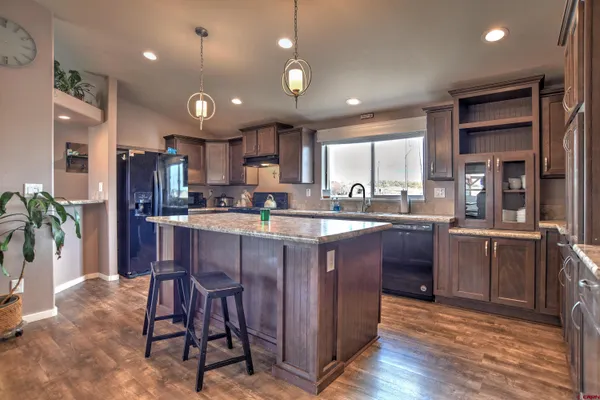 a kitchen with a sink appliances and cabinets