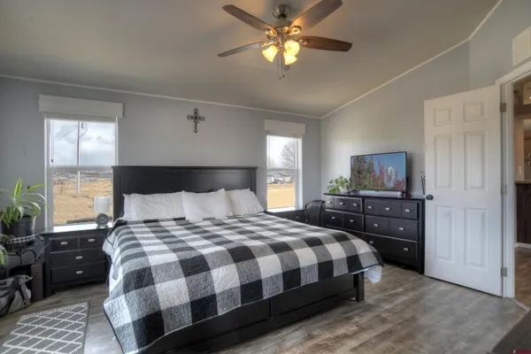 a bedroom with a bed and wooden floor