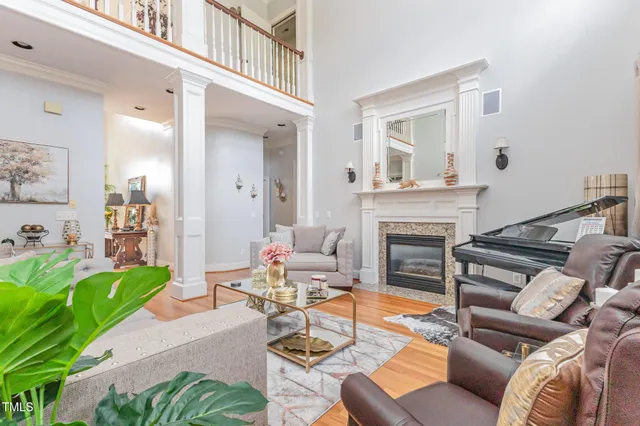 a living room with furniture a fireplace and a flat screen tv