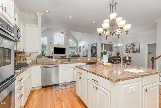 a bathroom with a sink a toilet and shower curtain
