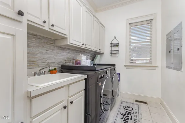 a spacious bedroom with two beds and a chandelier
