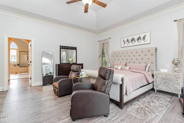 a bedroom with furniture and a wooden floor