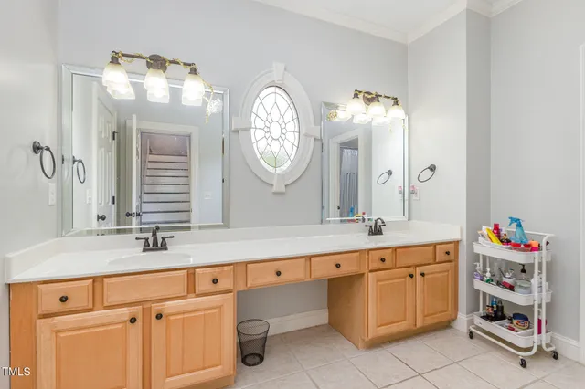 an aerial view of a house with a garden and lake view
