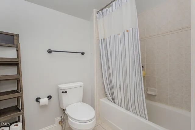 a front view of house with yard and trees around