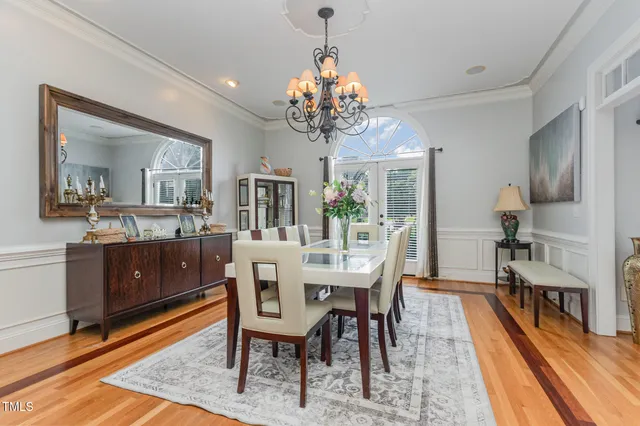 a view of a dining room with furniture and a chandelier