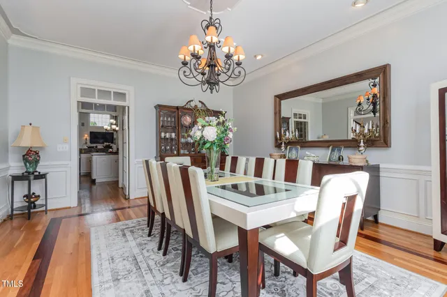 a view of a dining room with furniture wooden floor and chandelier