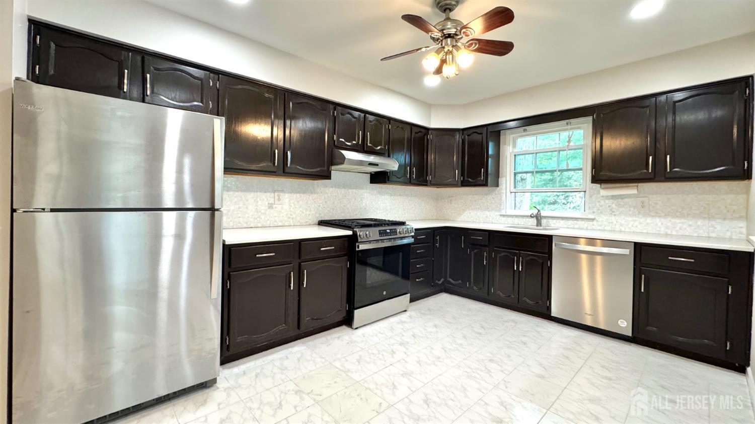 507 Timber Oaks Road Edison, NJ 08820 - Photo 8 of 17 a kitchen with a refrigerator sink and cabinets