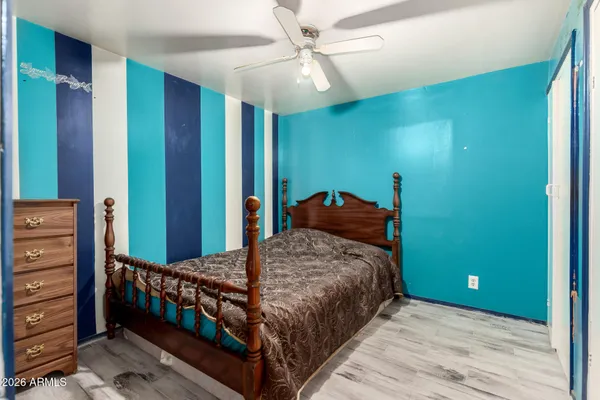 a bedroom with a bed and a dresser
