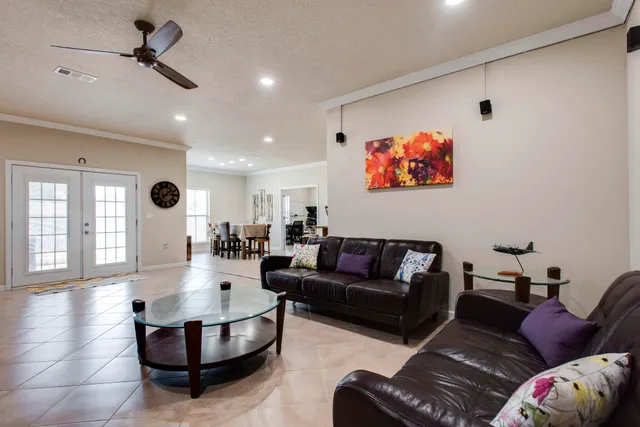 a kitchen with stainless steel appliances granite countertop a stove top oven a sink dishwasher a dining table and chairs with wooden cabinets