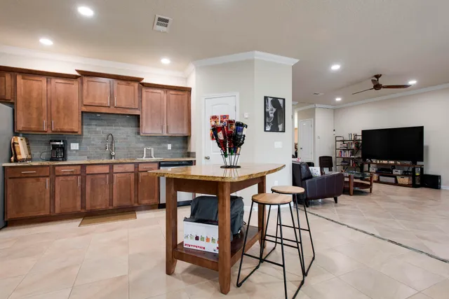 a kitchen with stainless steel appliances granite countertop a refrigerator a stove top oven a sink and dishwasher